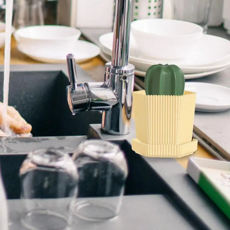 Cactus-shaped kitchen sponge holder next to a sink, designed for efficient dishwashing and cleaning.